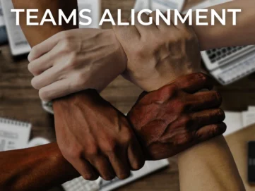 Team alignment concept with four diverse hands interlocked in unity, symbolising collaboration, trust, and cohesion in a professional workspace.